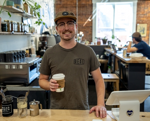 Broad Porch Coffee Company employee with coffee