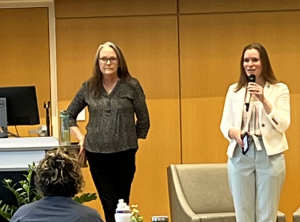 Two women speaking on stage at the childcare resource fair in 2024